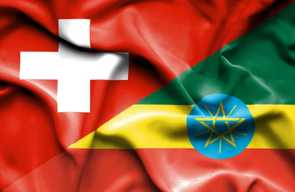 エチオピアとスイス連邦共和国の旗を振っています。 — ストック写真