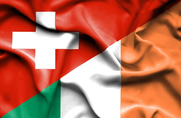 Írország és Svájc hullámzó zászlaja — Stock Fotó