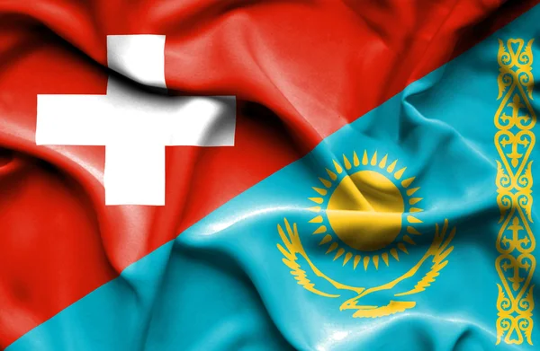 カザフスタンおよびスイス連邦共和国の旗を振っています。 — ストック写真