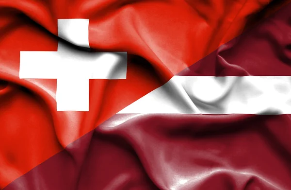 拉脱维亚和瑞士那飘扬的旗帜 — 图库照片