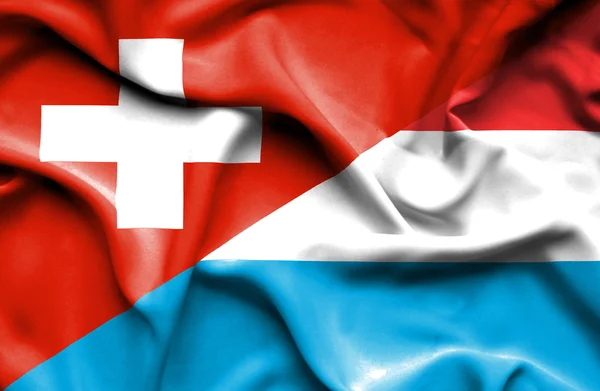 Luxemburg och Schweiz viftande flagga — Stockfoto