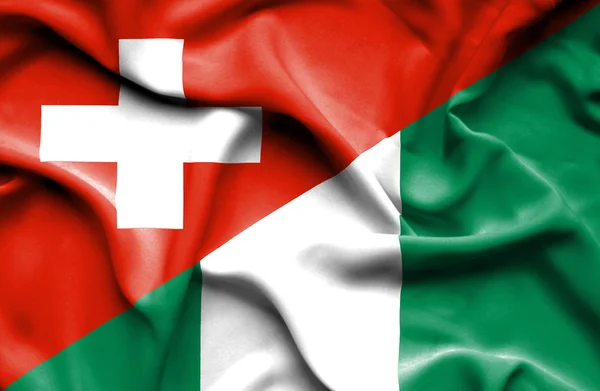 Waving flag of Nigeria and Switzerland — Stock Photo, Image