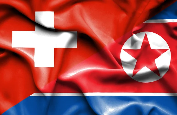 Waving flag of North Korea and Switzerland
