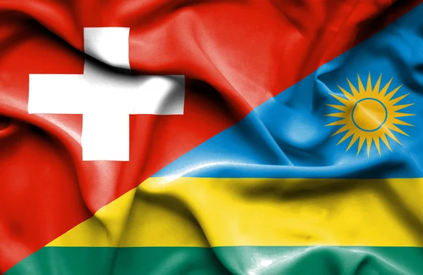 Flagge Ruandas und der Schweiz schwenken — Stockfoto