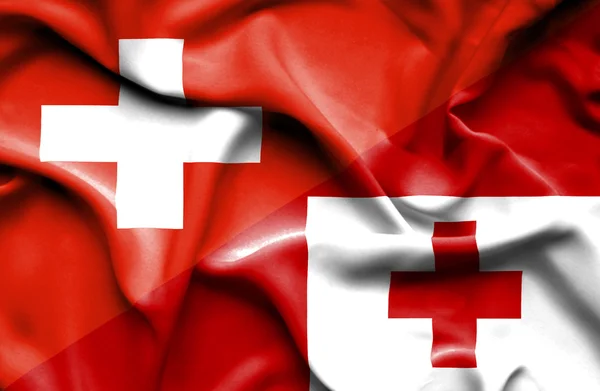Flagge von Tonga und der Schweiz schwenken — Stockfoto