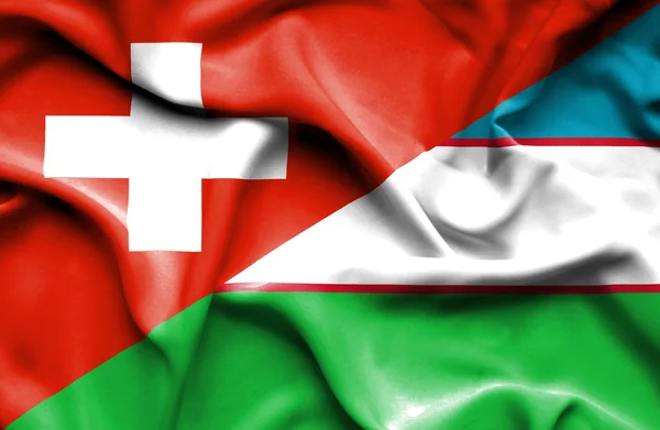 Üzbegisztán és Svájc hullámzó zászlaja — Stock Fotó
