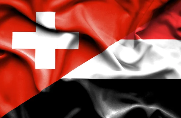 Bandeira ondulada do Iêmen e da Suíça — Fotografia de Stock