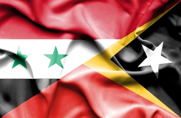 Östtimor och Syrien viftande flagga — Stockfoto