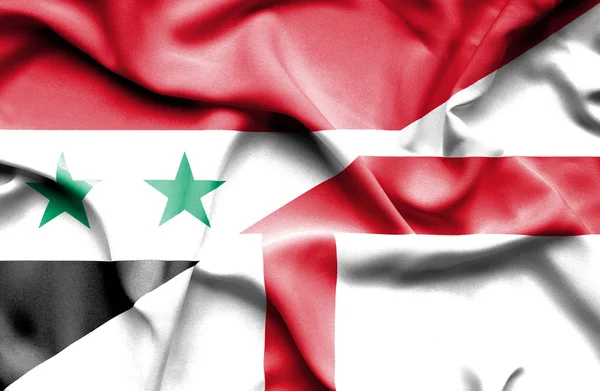 Macha flagą Anglii i syria — Zdjęcie stockowe