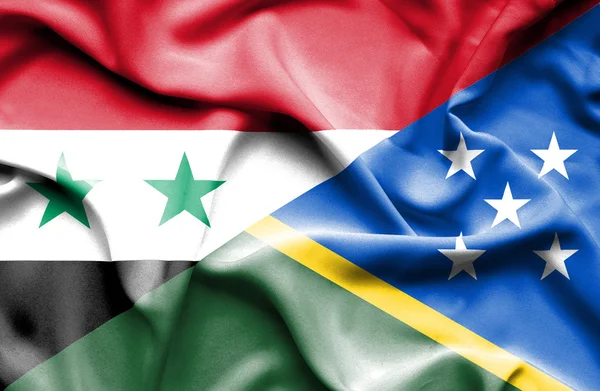 Wapperende vlag van Salomonseilanden en Syrië — Stockfoto