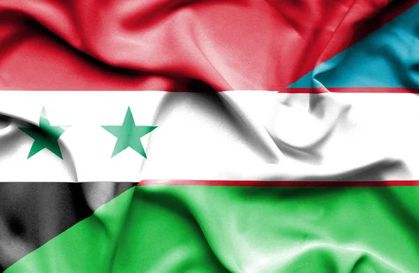 Machać flaga Uzbekistanu i syria — Zdjęcie stockowe