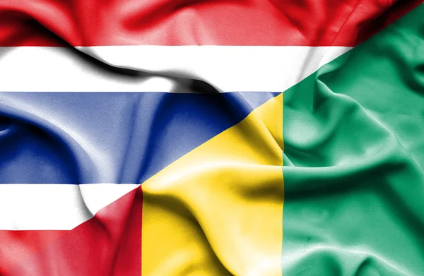 Waving flag of Guinea and Thailand — Stock Photo, Image