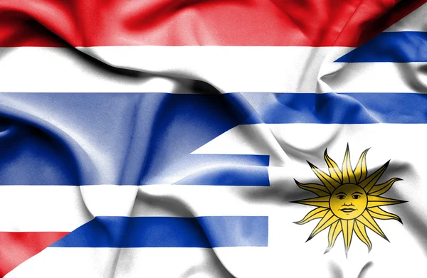 Waving flag of Uruguay and Thailand — Stock Photo, Image