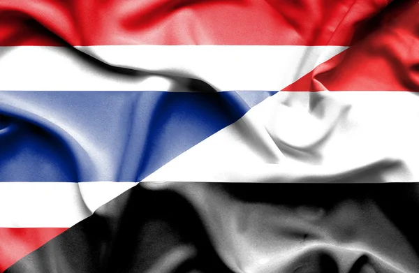 Flagge des Jemen und Thailands schwenkend — Stockfoto