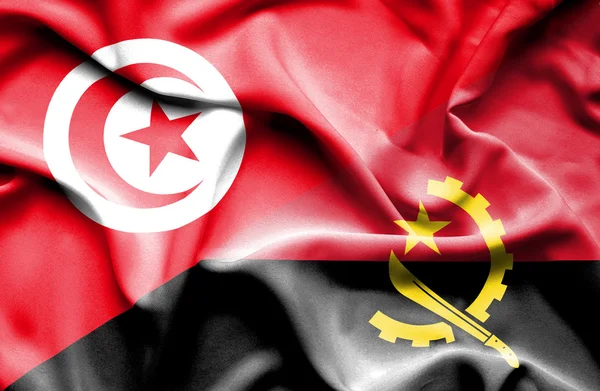 Waving flag of Angola and Tunisia — Stock Photo, Image