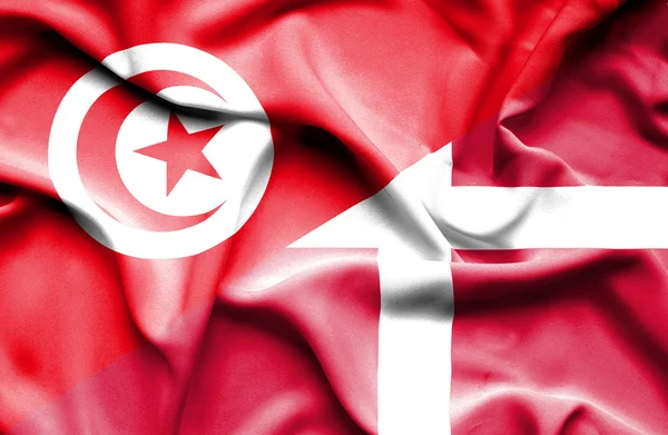 Waving flag of Denmark and Tunisia — Stock Photo, Image