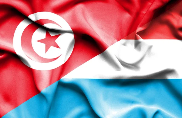 Waving flag of Luxembourg and Tunisia — Stock Photo, Image