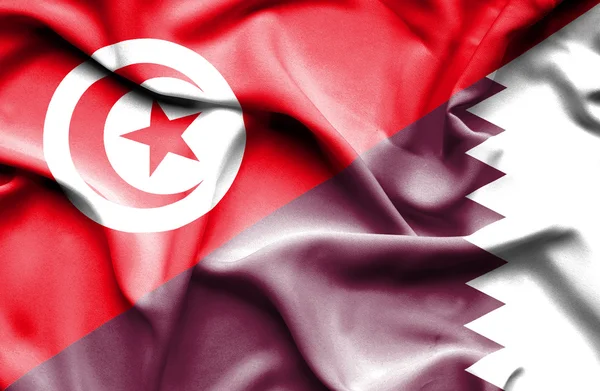 Waving flag of Qatar and Tunisia — Stock Photo, Image