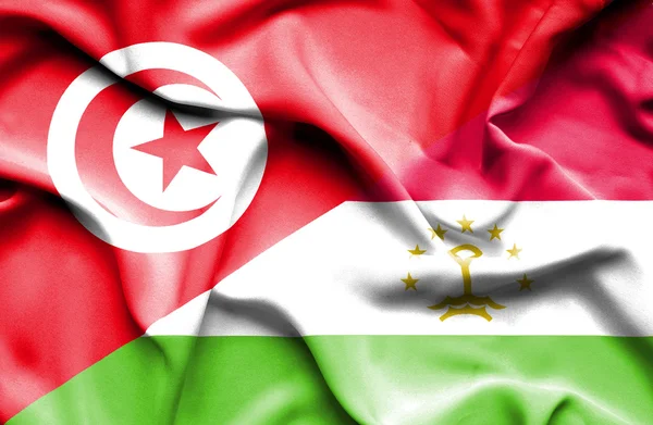 Waving flag of Tajikistan and Tunisia — Stock Photo, Image