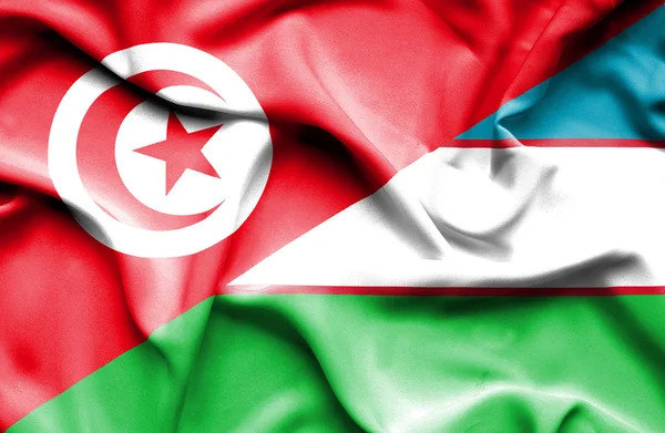Wapperende vlag van Oezbekistan en Tunesië — Stockfoto