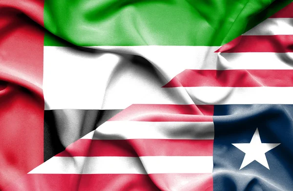 Mávání vlajkou Libérie a Spojené arabské emiráty — Stock fotografie