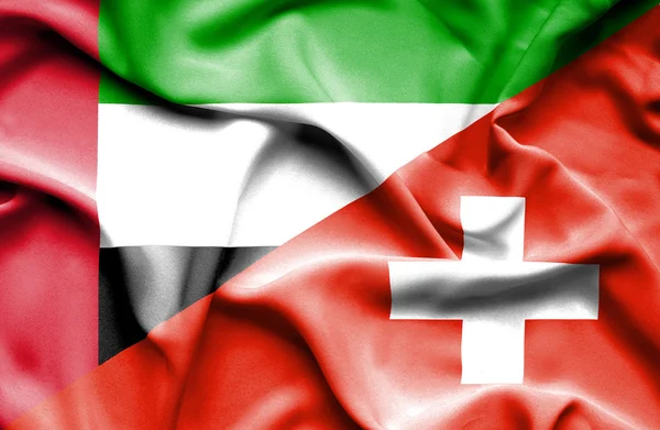 Integetett a Svájc és az Egyesült arab Emírségek zászlaja — Stock Fotó