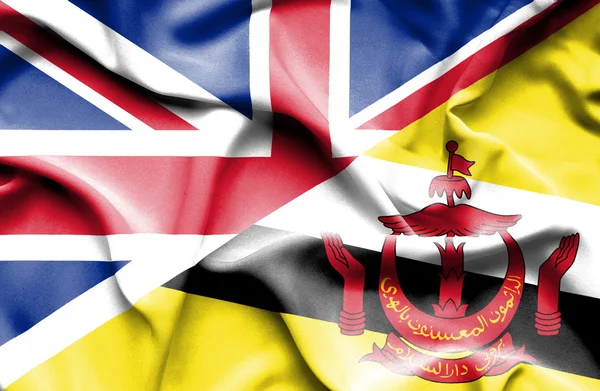 Vlající vlajka Bruneje a Velké Británie — Stock fotografie