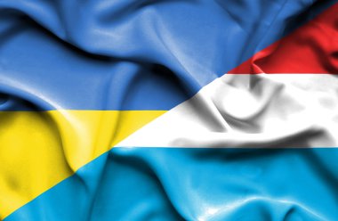 Waving flag of Luxembourg and Ukraine