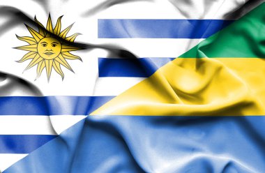 Waving flag of Gabon and Uruguay