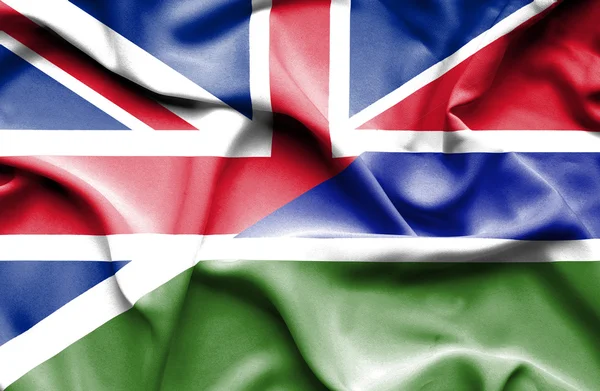 Waving flag of Gambia and Great Britain — Stock Photo, Image