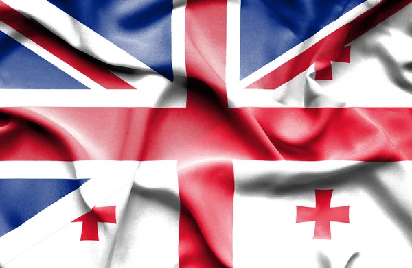 Waving flag of Georgia and Great Britain — Stock Photo, Image