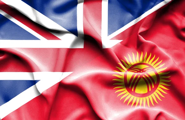 Waving flag of Kyrgyzstan and Great Britain — Stock Photo, Image