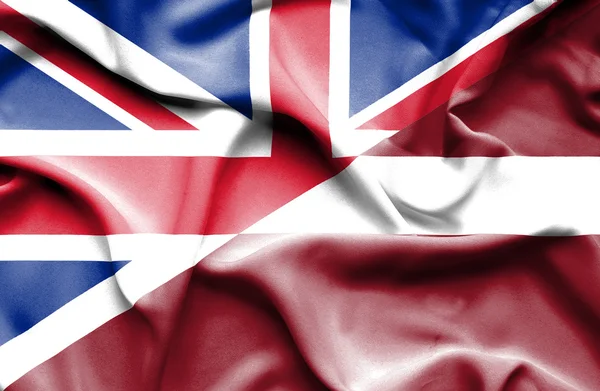 Waving flag of Latvia and Great Britain — Stock Photo, Image