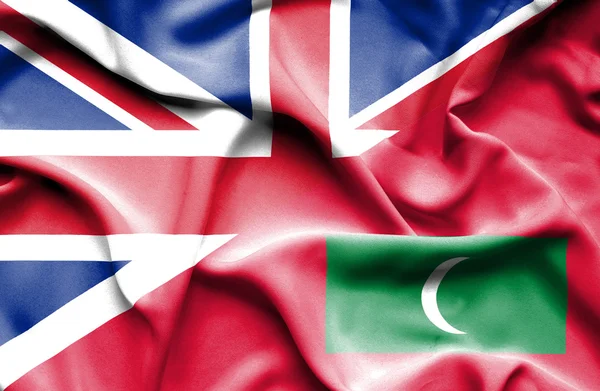 Waving flag of Maldives and Great Britain — Stock Photo, Image