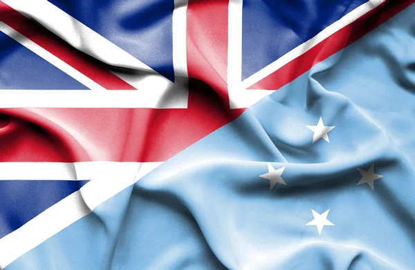 Vlající vlajka Mikronésie a Velké Británie — Stock fotografie