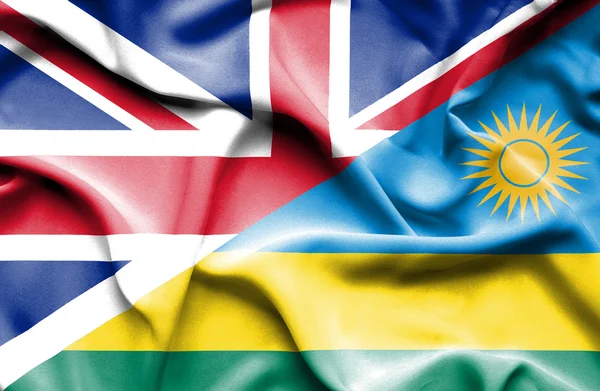 Waving flag of Rwanda and Great Britain — Stock Fotó