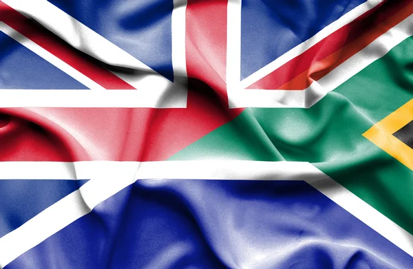 Waving flag of South Africa and Great Britain — Stockfoto