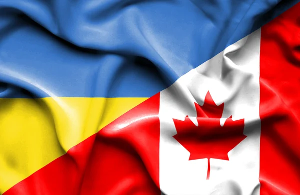 Waving flag of Canada and Ukraine — Stok fotoğraf
