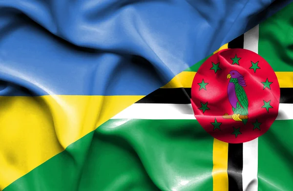 Waving flag of Dominica and Ukraine — ストック写真