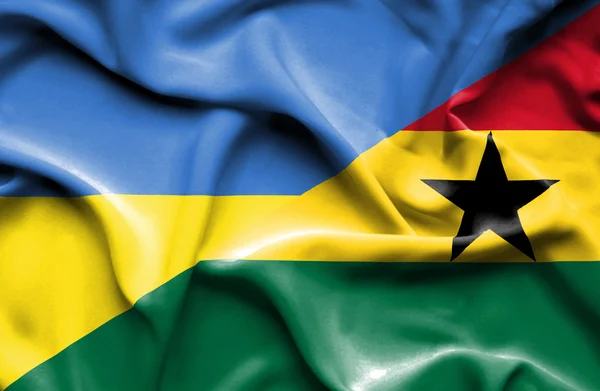 Waving flag of Ghana and Ukraine — Stok fotoğraf