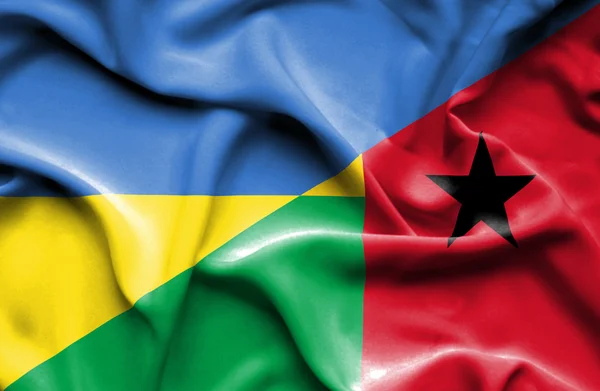 Waving flag of Guinea Bissau and Ukraine — Stock fotografie
