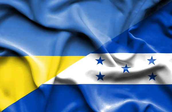 Waving flag of Honduras and Ukraine — Zdjęcie stockowe