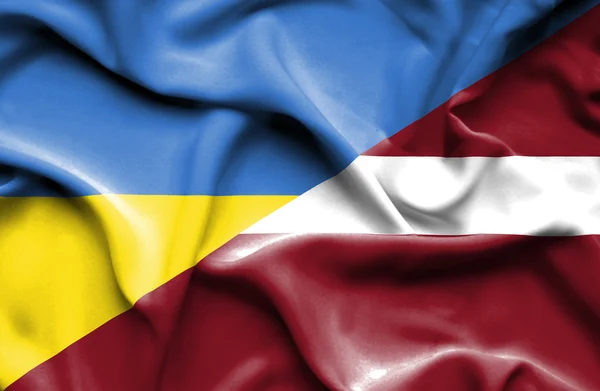 Waving flag of Latvia and Ukraine — ストック写真