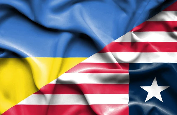 Waving flag of Liberia and Ukraine — Stock Photo, Image