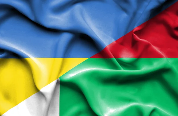 Waving flag of Madagascar and Ukraine — Stock Photo, Image