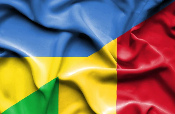 Waving flag of Mali and Ukraine — Stok fotoğraf