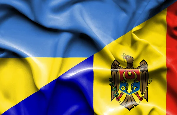 Waving flag of Moldavia and Ukraine — Stockfoto