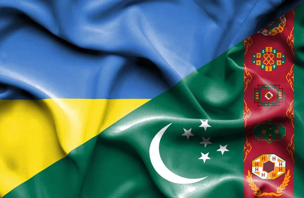 Waving flag of Turkmenistan and Ukraine — Stock Photo, Image