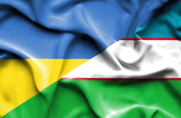 Uzbekistan och Ukraina viftande flagga — Stockfoto