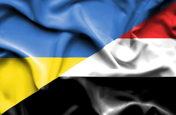 Waving flag of Yemen and Ukraine — Stock Photo, Image